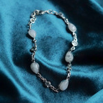 Rainbow moonstone and blue topaz link bracelet, 'Misty Sky' - Blue Topaz and Rainbow Moonstone Gemstone Station Bracelet