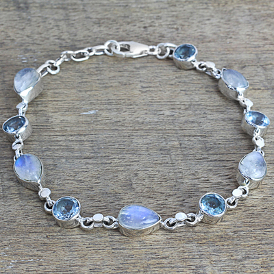 Rainbow moonstone and blue topaz link bracelet, 'Misty Sky' - Blue Topaz and Rainbow Moonstone Gemstone Station Bracelet