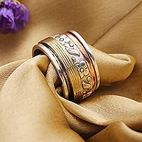 Sterling silver meditation spinner ring, 'Floral Sheen' - Sterling Silver Copper and Brass Indian Floral Spinner Ring