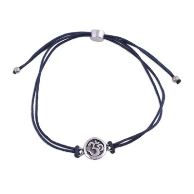 Sterling silver pendant bracelet, 'Om Saga in Blue' - Sterling Silver and Blue Cotton Cord Om Pendant Bracelet