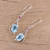 Rhodium plated blue topaz and ruby dangle earrings, 'Enthralling Sky' - Indian Blue Topaz and Ruby Sterling Silver Dangle Earrings (image 2b) thumbail