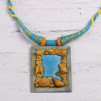 Ceramic pendant necklace, 'Birdsong' - Handcrafted Ceramic Blue and Gold Bird Frame Necklace
