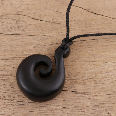 Ebony wood pendant necklace, 'Curling Wave' - Hand Carved Ebony Wood Swirl Motif Pendant Necklace