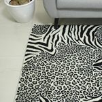 Hand-tufted wool area rug, 'Wild Harmony' - Zebra and Leopard Black and White Hand Tufted Wool Area Rug