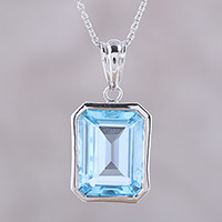 Rhodium plated blue topaz pendant necklace,