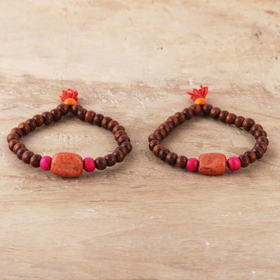 Wood and resin beaded stretch bracelets, 'Friendship Beads' (pair) - Wood and Orange Resin Beaded Stretch Bracelets (Pair)