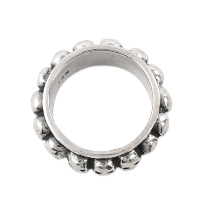 Sterling silver spinner ring, 'Skull Row' - Skull Pattern Sterling Silver Spinner Ring from Bali