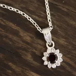 Garnet pendant necklace, 'Gleaming Flower' - Floral Garnet Pendant Necklace from India