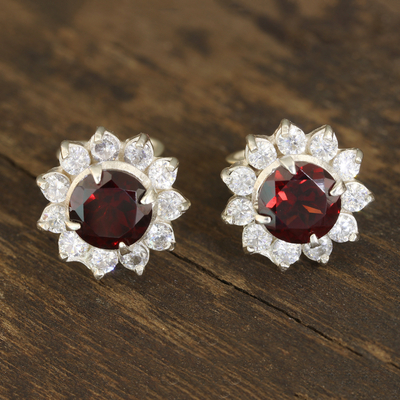 Garnet stud earrings, 'Gleaming Flower' - Floral Garnet Stud Earrings Crafted in India