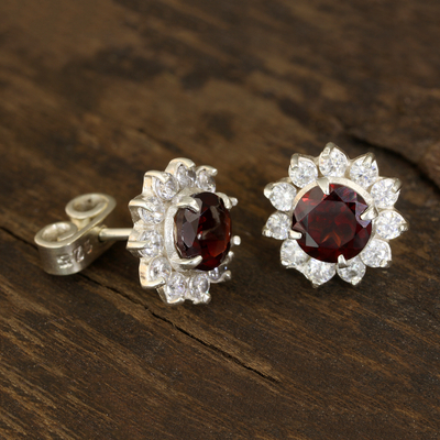 Garnet stud earrings, 'Gleaming Flower' - Floral Garnet Stud Earrings Crafted in India