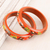 Wood bangle bracelets, 'Vermilion Garden' (pair) - Floral Haldu Wood Bangle Bracelets in Vermilion (Pair) thumbail