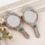 aluminium hand mirrors, 'Leafy Paradise' (pair) - Pair of Antiqued aluminium Hand Mirrors with Beads from India