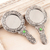 aluminium hand mirrors, 'Scallop Beauty' (pair) - Pair of Antiqued aluminium Hand Mirrors with Beads from India