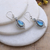 Chalcedony and blue topaz dangle earrings, 'Heaven's Triumph' - Chalcedony Cabochon and Blue Topaz Dangle Earrings