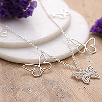 Sterling silver charm necklace, 'Enchanted Desires' - Polished Butterfly-Themed Sterling Silver Charm Necklace