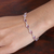 Amethyst link bracelet, 'Sagacity Rain' - 9-Carat Faceted Amethyst Link Bracelet Crafted in India