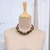 Wood beaded necklace, 'Tribal Dimension' - Geometric Green and Brown Haldu Wood Beaded Necklace