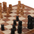 Wood chess set, 'Challenge of Kings' - Hand-Painted Brown and Black Wood Chess Set from India