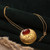 Onyx pendant necklace, 'Glowing Flame' - High-Polished Brass and Red Onyx Pendant Necklace