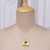 Onyx pendant necklace, 'Glowing Flame' - High-Polished Brass and Red Onyx Pendant Necklace