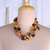 Wood beaded station necklace, 'Solar Alliance' - Brown and Black Haldu Wood Station Necklace Made in India