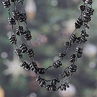 Wood beaded strand necklace, 'Midnight Loops' - Handcrafted Haldu Wood Beaded Three-Strand Necklace in Black