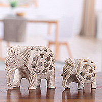 Soapstone sculptures, 'Elephant Bonds' (set of 2) - Jali-Themed 2-Piece Carved Soapstone Elephant Sculpture Set