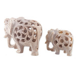 Soapstone sculptures, 'Elephant Bonds' (set of 2) - Jali-Themed 2-Piece Carved Soapstone Elephant Sculpture Set