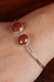 Carnelian cuff bracelet, 'Fiery Aura' - Minimalist 11-Carat Faceted Round Carnelian Cuff Bracelet