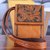 Leather sling bag, 'Timeless Elegance in Tan' - Tan Leather Sling Bag with Embossed Floral Paisley Designs