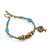 Resin and brass beaded charm bracelet, 'Tree of Calm' - Brass and Turquoise-Toned Resin Beaded Tree Charm Bracelet