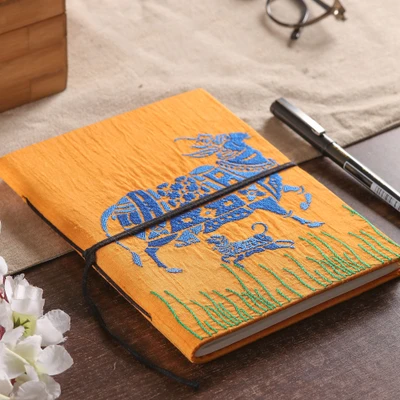 Handmade paper journal, 'Kamadhenu in Saffron' - Folk Art-Inspired 58-Page Handmade Paper Journal from India