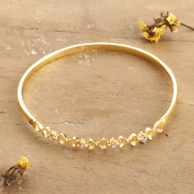 Cubic zirconia pendant bangle bracelet, 'Everlasting Hearts' - Heart-Themed Cubic Zirconia Brass Pendant Bangle Bracelet