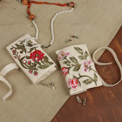 Embroidered jewelry rolls, 'Enchanted Paradise' (set of 2) - Spring-Themed 2-Piece Rayon Embroidered Jewelry Roll Set