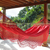 Cotton hammock with spreader bars, 'Tropical Red' (single) - Red Hand Woven Cotton Hammock with Spreader Bar (Single) thumbail