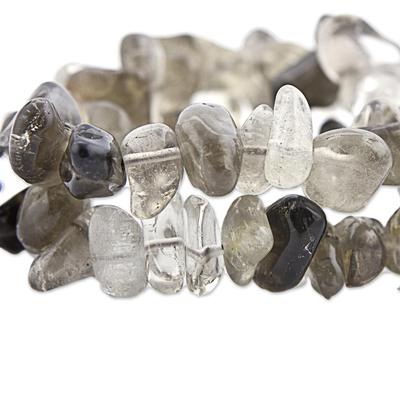 Smoky quartz and crystal stretch bracelets, 'Translucent Crystal' (pair) - Smoky and Clear Quartz Stretch Bracelets (Pair) from Brazil