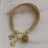 Gold accented golden grass charm bracelet, 'Romantic Dolphins'