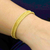 Armband mit goldfarbenem Grasarmband mit Akzent, 'Gleam of the Sun - Armband mit goldenem Grasarmband mit Goldakzenten aus Brasilien