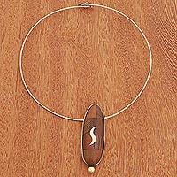 Gold accented wood pendant necklace, 'Gold Squiggle' - Gold Accented Oval Wood Pendant Necklace from Brazil