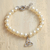 Swarovski crystal pearl charm bracelet, 'Eternal Trinity' - Trinity Knot Pearl Bracelet with Swarovski Crystals thumbail