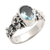 Blue topaz single stone ring, 'Frangipani Path' - Oval Cut Blue Topaz and Silver Ring with Floral Design thumbail
