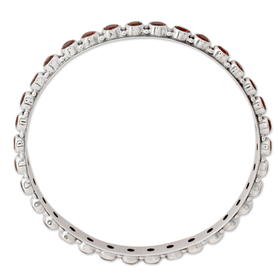 Garnet bangle bracelet, 'Love's Energy' - 15-carat Garnet Fair Trade Silver Bangle Bracelet from India
