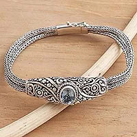 Blue topaz pendant bracelet, 'Double Naga' - Balinese Blue Topaz Bracelet with Sterling Silver Naga Chain