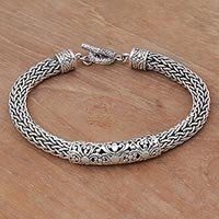 Sterling silver braided bracelet, 'Floral Dragon' - Artisan Braided Sterling Silver Floral Pendant Bracelet