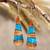 Wood and resin dangle earrings, 'Oceanic Dimension' - Drop-Shaped Apricot Wood Blue Resin Dangle Earrings