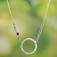 Garnet pendant necklace, 'Circular Orbit' - Peruvian Sterling Silver Pendant Necklace with Garnet