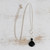 Quartz and agate Y necklace, 'Clarity and Shadow' - Black Agate and Crystal Quartz Necklace from Brazil