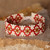 Glass beaded wristband bracelet, 'Spring Desire' - Folk Art Spring-Themed Red Glass Beaded Wristband Bracelet