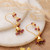 Gold-plated garnet chandelier earrings, 'Golden Jhumka' - Gold-Plated Chandelier Earrings with Garnet Gemstones (image 2b) thumbail