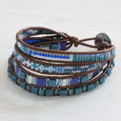 Beaded wristband bracelet, 'Sparkling Moon' - Handmade Four Strand Blue Bead Bracelet with Leather Binding
